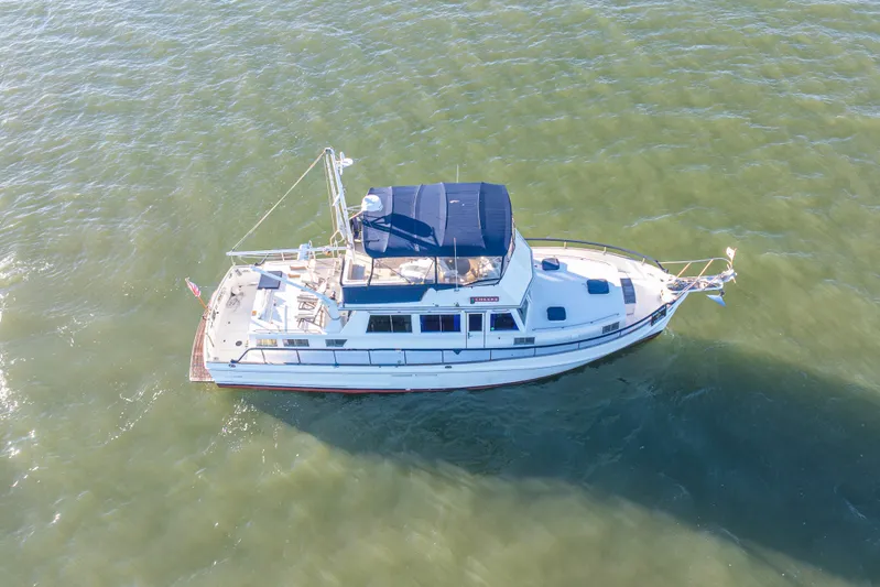 Cheers Yacht Photos Pics Aerial view of 1989 Grand Banks 46 Classic yacht on open water.
