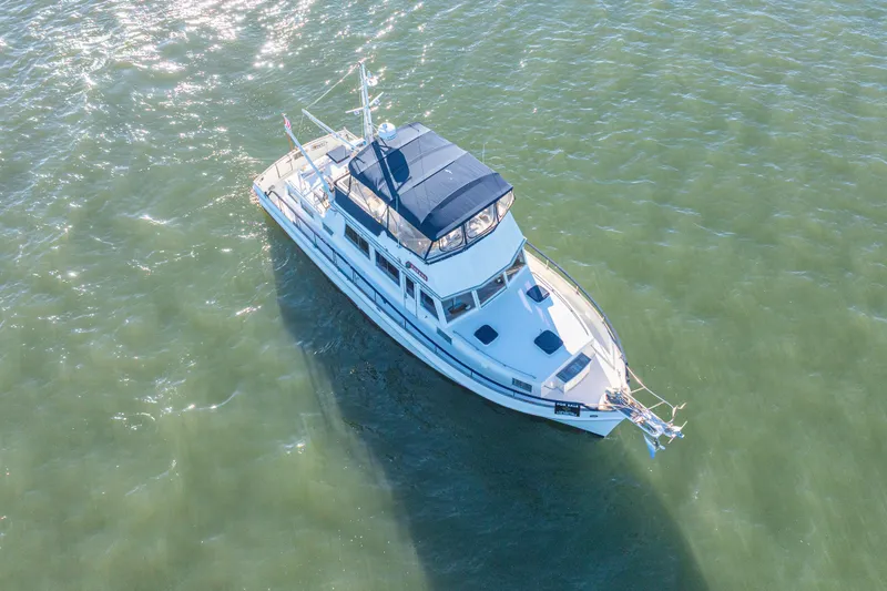 Cheers Yacht Photos Pics Aerial view of 1989 Grand Banks 46 Classic yacht on calm water.