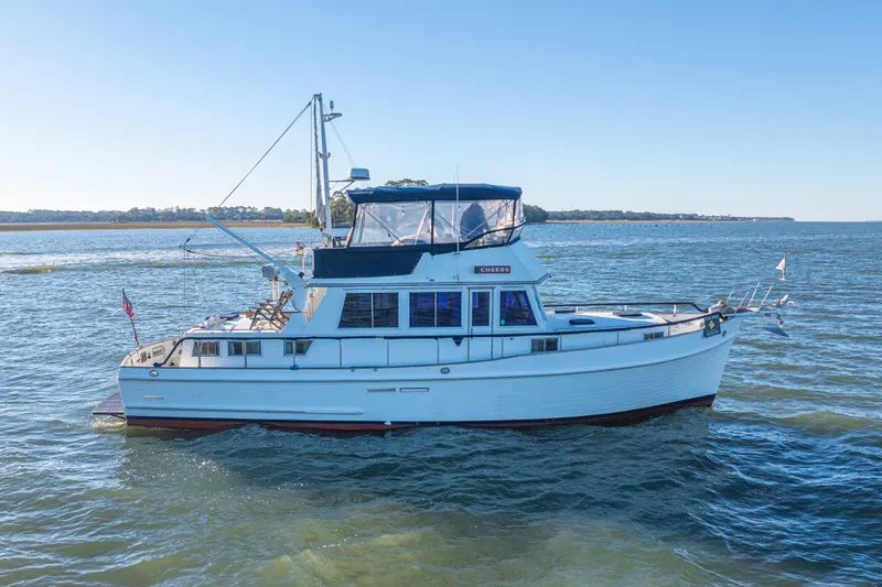 Cheers Yacht Photos Pics 1989 Grand Banks 46 Classic yacht cruising on open water under clear blue sky.