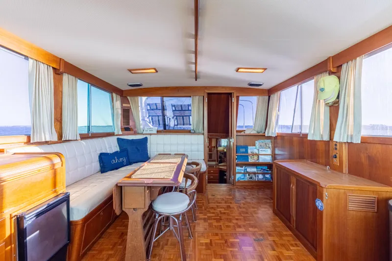 Cheers Yacht Photos Pics Interior of 1989 Grand Banks 46 Classic yacht with wood paneling and seating area.