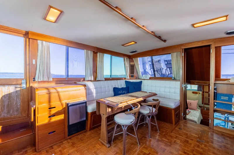 Cheers Yacht Photos Pics Interior of 1989 Grand Banks 46 Classic yacht with wood finish and seating area.
