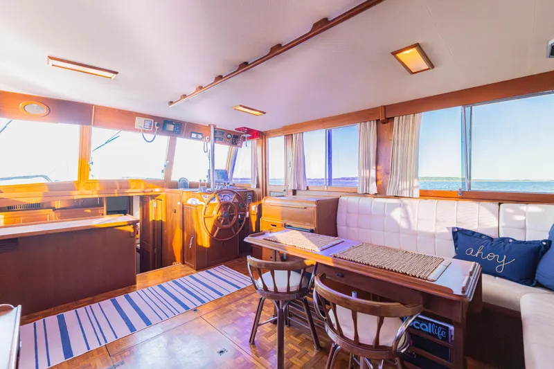 Cheers Yacht Photos Pics Interior of 1989 Grand Banks 46 Classic yacht with wooden decor and ocean view.