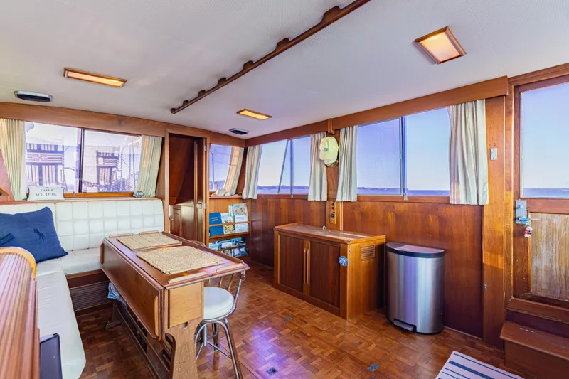 Cheers Yacht Photos Pics Interior of 1989 Grand Banks 46 Classic yacht with wood paneling and seating area.