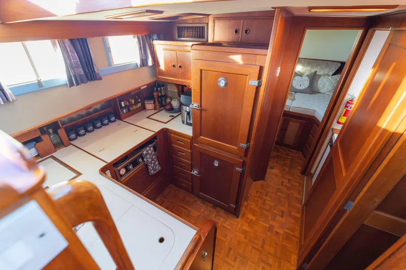 Cheers Yacht Photos Pics 1989 Grand Banks 46 Classic yacht interior with wooden cabinetry and cozy bedroom.