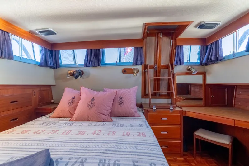Cheers Yacht Photos Pics Cozy cabin interior of 1989 Grand Banks 46 Classic yacht with wooden furnishings and nautical decor.