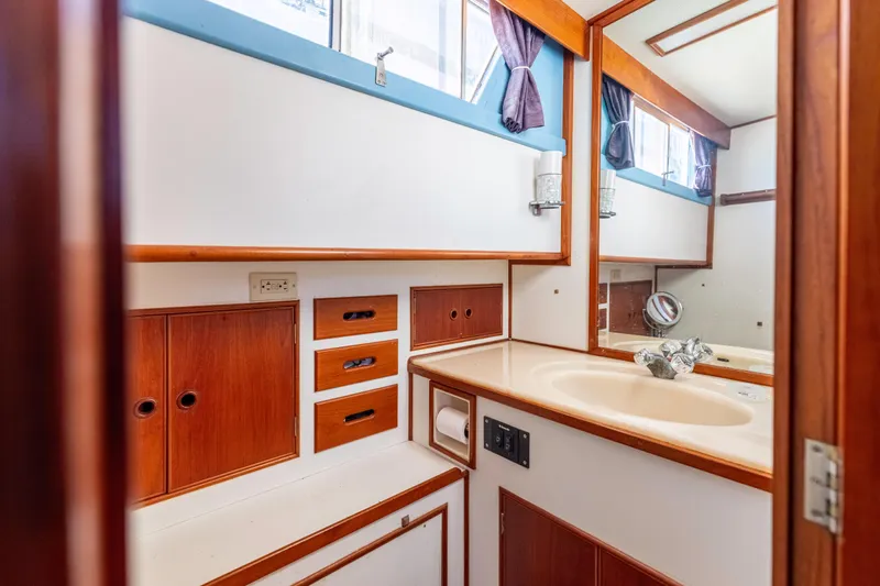 Cheers Yacht Photos Pics 1989 Grand Banks 46 Classic yacht bathroom with wood cabinetry and sink.