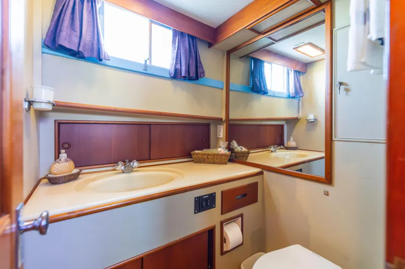 Cheers Yacht Photos Pics Bathroom interior of 1989 Grand Banks 46 Classic yacht with mirror and sink.
