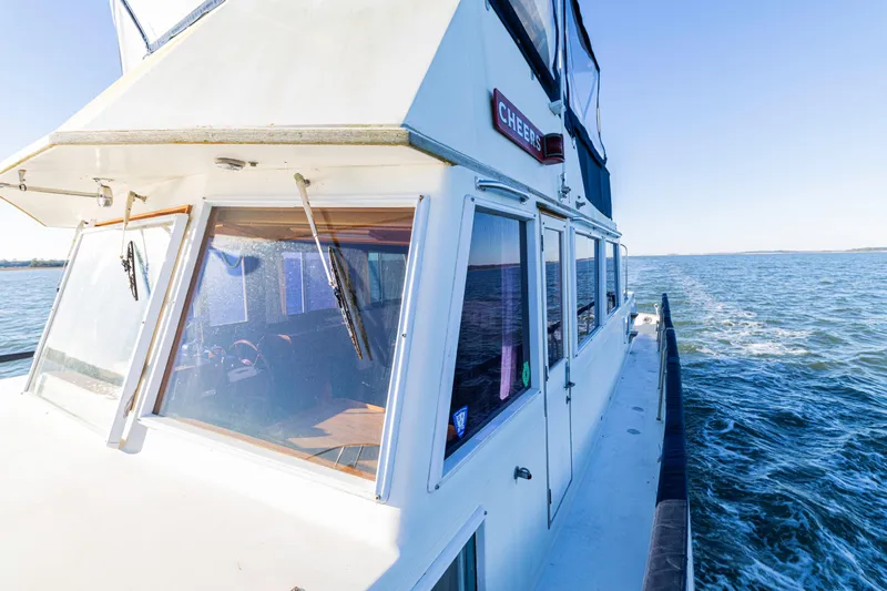 Cheers Yacht Photos Pics 1989 Grand Banks 46 Classic yacht cruising on open water under clear blue skies.
