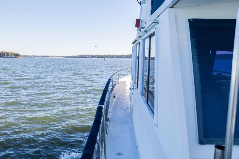 Cheers Yacht Photos Pics 1989 Grand Banks 46 Classic yacht cruising on calm waters under clear skies.