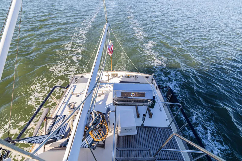 Cheers Yacht Photos Pics 1989 Grand Banks 46 Classic yacht cruising on open water, rear deck view.