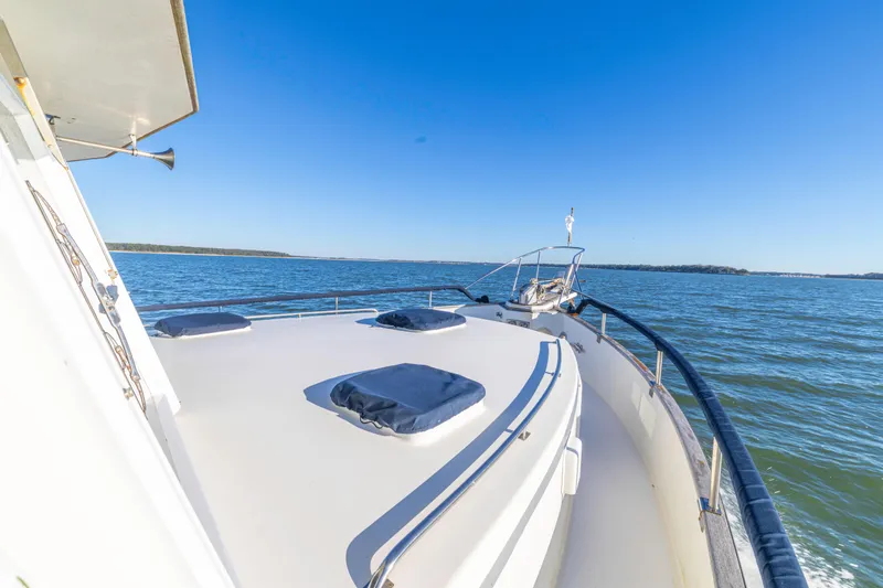 Cheers Yacht Photos Pics 1989 Grand Banks 46 Classic yacht cruising on open water under clear blue sky.