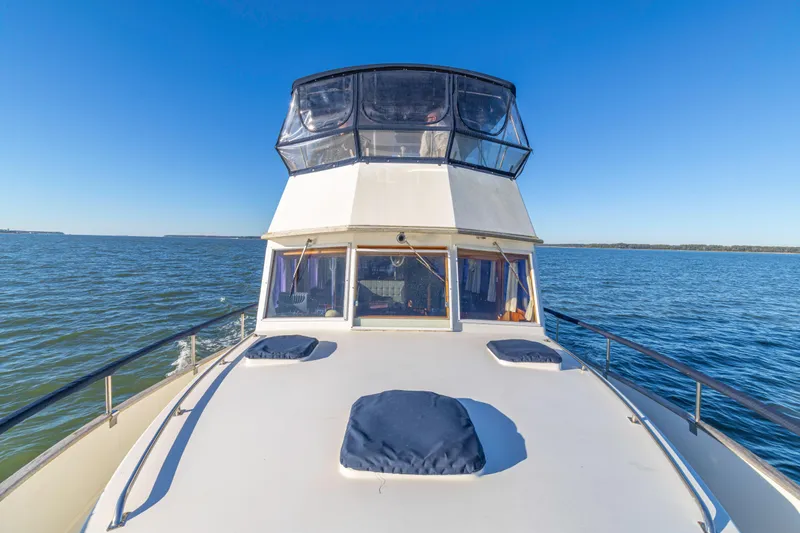Cheers Yacht Photos Pics 1989 Grand Banks 46 Classic yacht cruising on open water under clear blue skies.