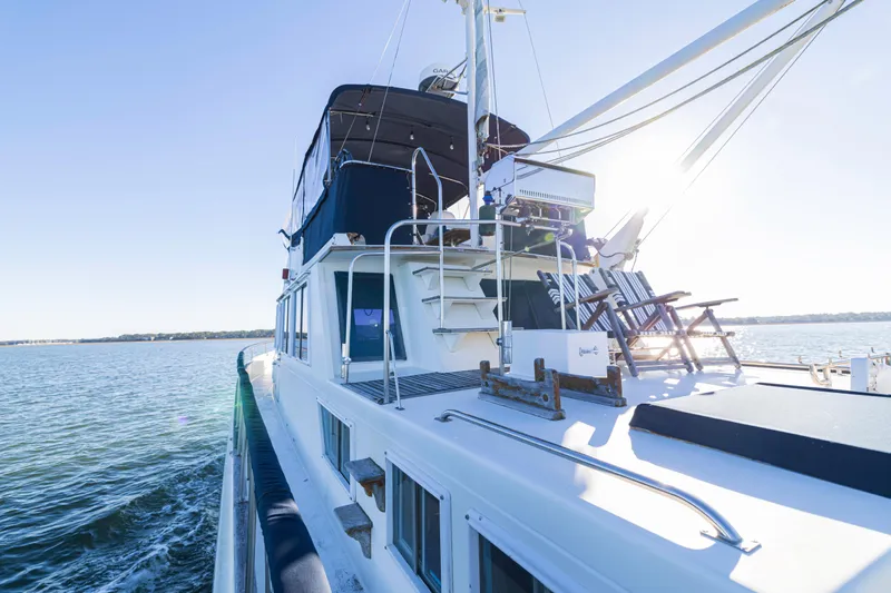 Cheers Yacht Photos Pics 1989 Grand Banks 46 Classic yacht cruising on calm waters under clear blue skies.