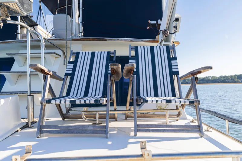 Cheers Yacht Photos Pics Two striped deck chairs on a 1989 Grand Banks 46 Classic yacht.