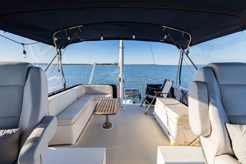 Cheers Yacht Photos Pics 1989 Grand Banks 46 Classic yacht interior with seating, table, and ocean view.