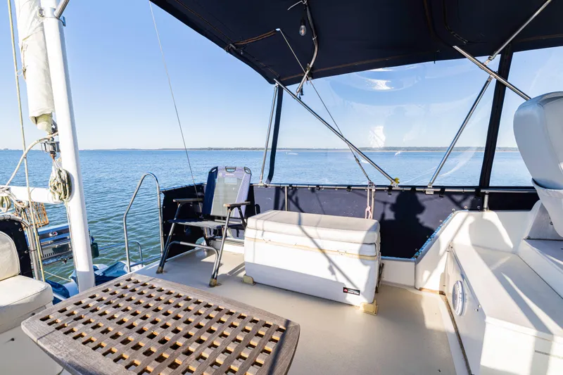 Cheers Yacht Photos Pics 1989 Grand Banks 46 Classic yacht deck with seating, overlooking calm waters.