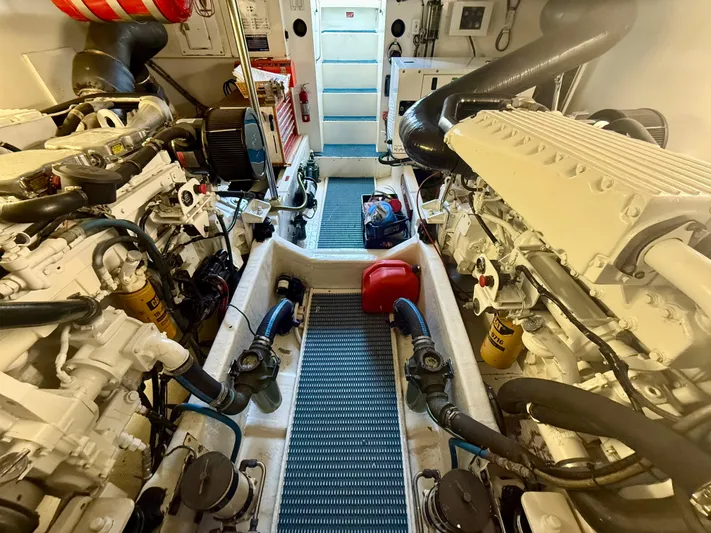 Cavileah Yacht Photos Pics Engine room of 1997 West Bay Sonship 58 Pilothouse with dual engines and equipment.