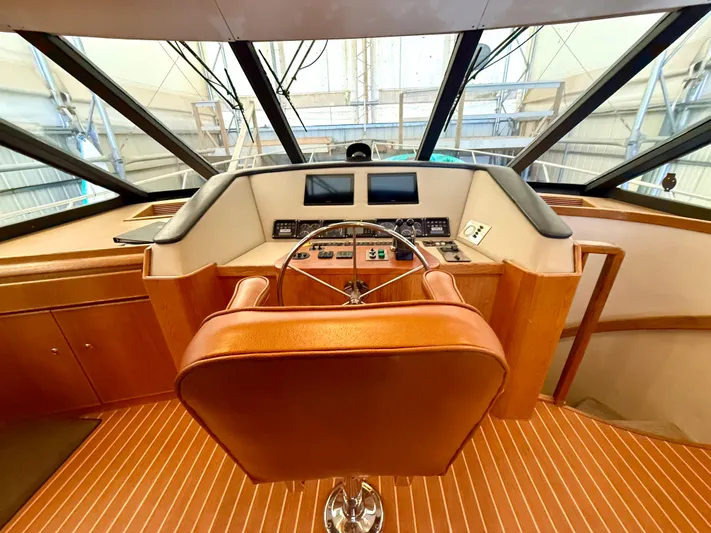 Cavileah Yacht Photos Pics Pilothouse interior of 1997 West Bay Sonship 58, featuring helm and captain's chair.