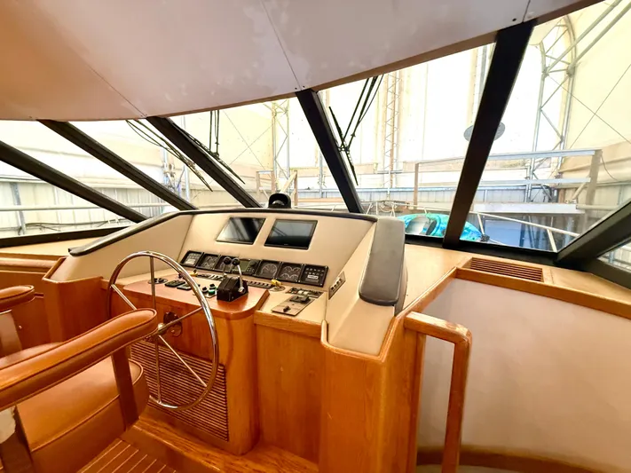 Cavileah Yacht Photos Pics Pilothouse interior of 1997 West Bay Sonship 58, featuring steering wheel and control panel.