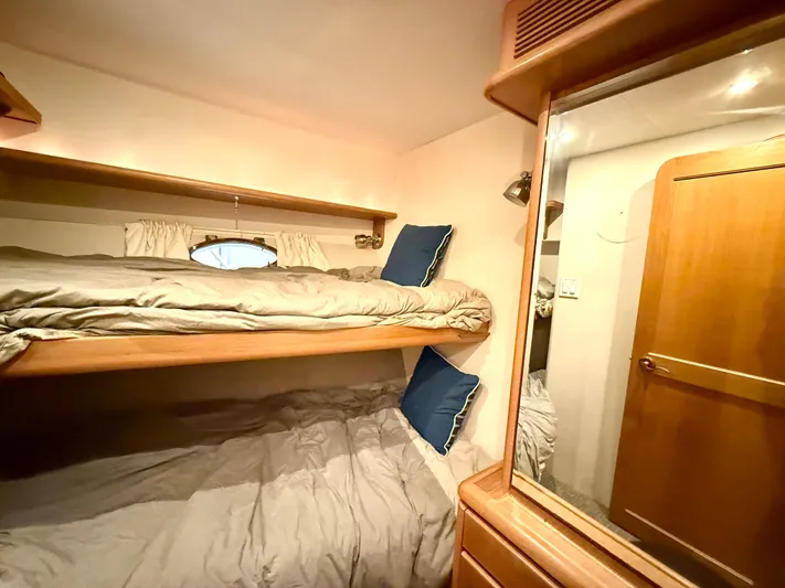 Cavileah Yacht Photos Pics Cozy bunk beds in 1997 West Bay Sonship 58 Pilothouse cabin with wooden accents.