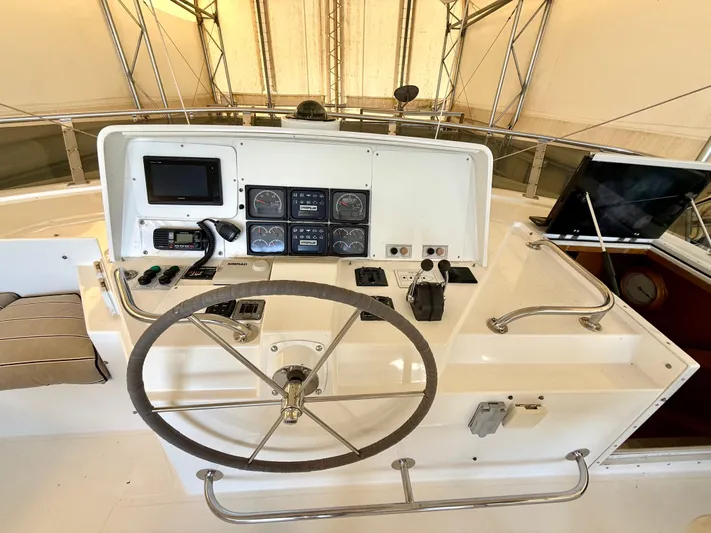 Cavileah Yacht Photos Pics 1997 West Bay Sonship 58 Pilothouse helm with steering wheel and control panel.