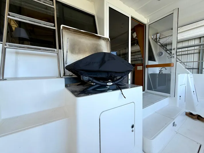 Cavileah Yacht Photos Pics Outdoor deck of 1997 West Bay Sonship 58 Pilothouse with grill and ladder.