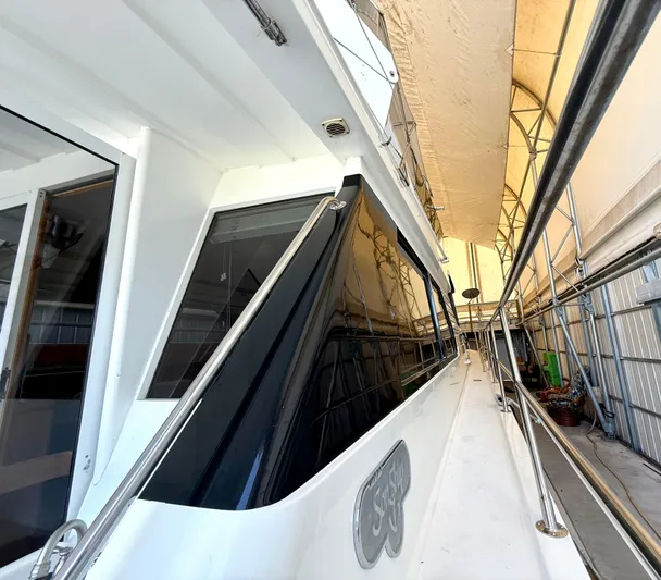 Cavileah Yacht Photos Pics 1997 West Bay Sonship 58 Pilothouse yacht in covered storage, side view.