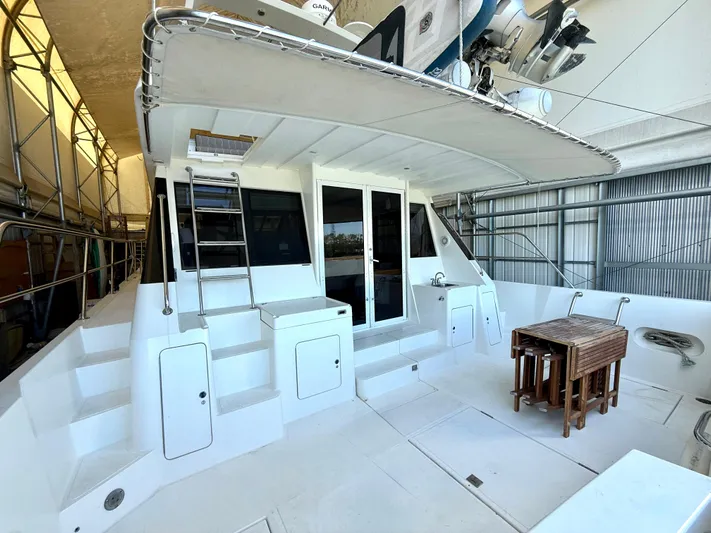 Cavileah Yacht Photos Pics 1997 West Bay Sonship 58 Pilothouse yacht deck with seating and ladder.