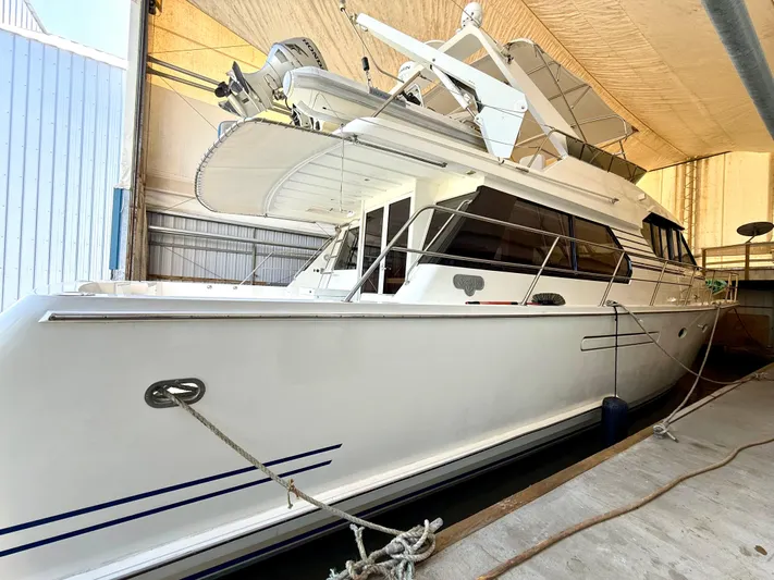 Cavileah Yacht Photos Pics 1997 West Bay Sonship 58 Pilothouse yacht docked in a covered marina.