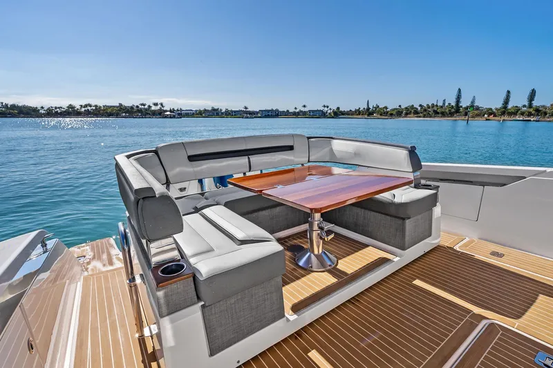 Miss Marie Yacht Photos Pics 2019 Tiara Yachts 38 LS with elegant seating and table on deck, overlooking serene waters.
