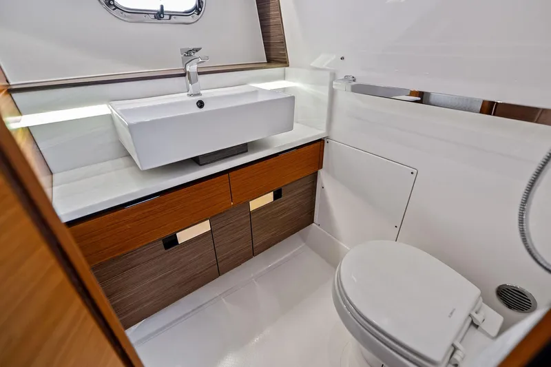 Miss Marie Yacht Photos Pics Luxurious bathroom in 2019 Tiara Yachts 38 LS, featuring modern sink and toilet.