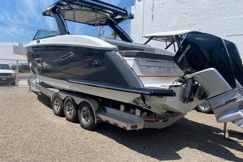 Casa - 2023 Cobalt R33 Ob @ Vallarta Yacht Photos Pics 2023 Cobalt R33 Outboard boat on trailer, featuring sleek design and powerful Mercury engine.