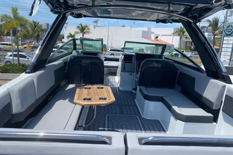 Casa - 2023 Cobalt R33 Ob @ Vallarta Yacht Photos Pics 2023 Cobalt R33 Outboard boat interior with seating and wooden table.