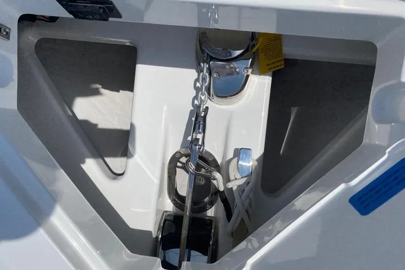 Casa - 2023 Cobalt R33 Ob @ Vallarta Yacht Photos Pics Anchor compartment of 2023 Cobalt R33 Outboard boat with chain and rope.
