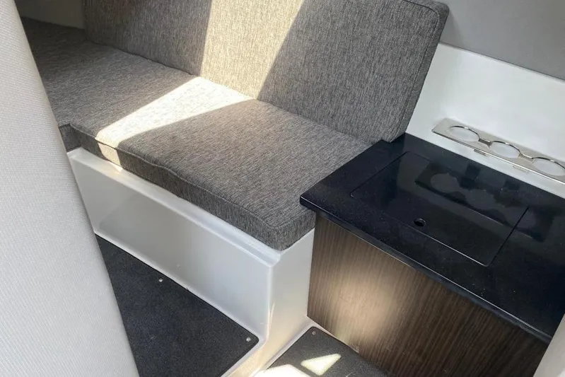 Casa - 2023 Cobalt R33 Ob @ Vallarta Yacht Photos Pics 2023 Cobalt R33 Outboard interior with gray seating and sleek black countertop.