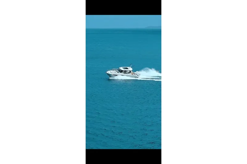  Yacht Photos Pics 2024 Boston Whaler 405 Conquest cruising on open blue water.