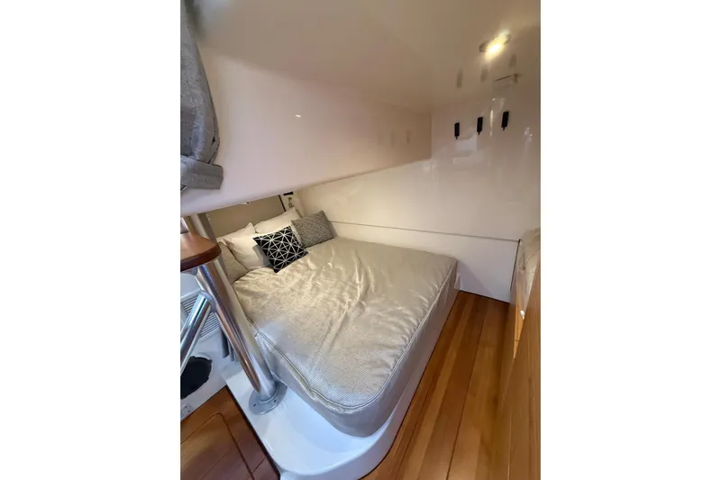  Yacht Photos Pics 2024 Boston Whaler 405 Conquest cabin interior with cozy bed and modern design.