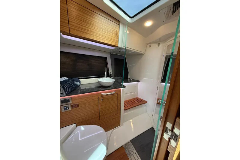  Yacht Photos Pics 2024 Boston Whaler 405 Conquest interior bathroom with modern fixtures and wooden accents.
