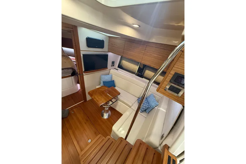  Yacht Photos Pics Luxurious interior of 2024 Boston Whaler 405 Conquest yacht with wood accents and seating.