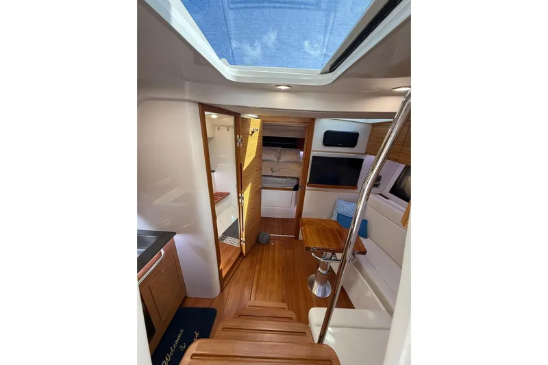  Yacht Photos Pics 2024 Boston Whaler 405 Conquest interior with wood flooring and seating area.