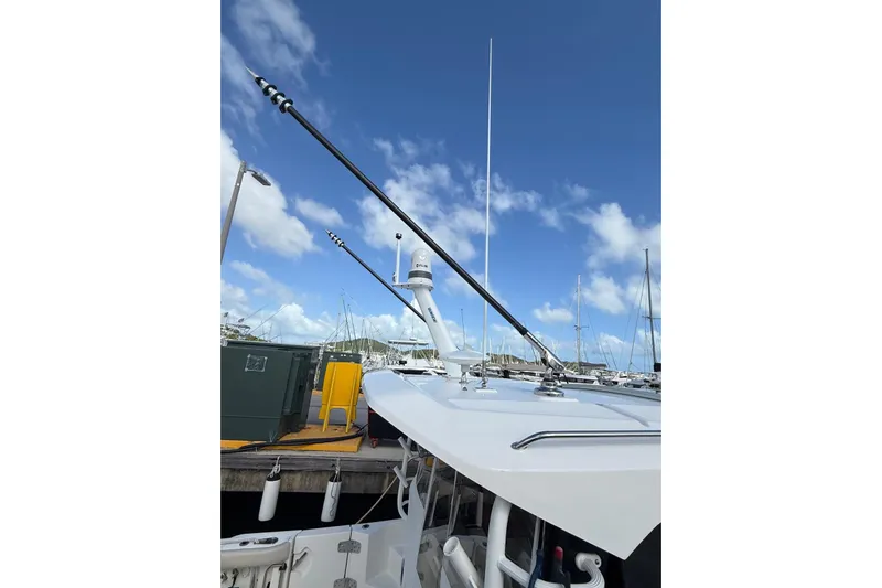 Yacht Photos Pics 2024 Boston Whaler 405 Conquest boat docked under clear blue sky.