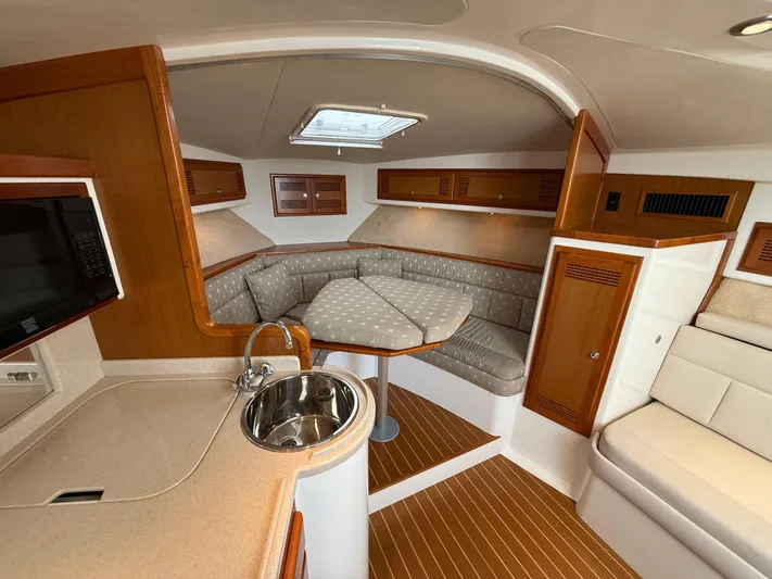 Club Car Yacht Photos Pics Interior of 1999 Cabo 31 Express boat with kitchenette and seating area.