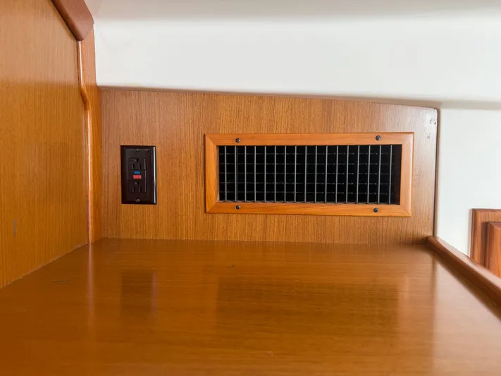 Club Car Yacht Photos Pics Wooden interior of 1999 Cabo 31 Express boat with vent and electrical outlet.