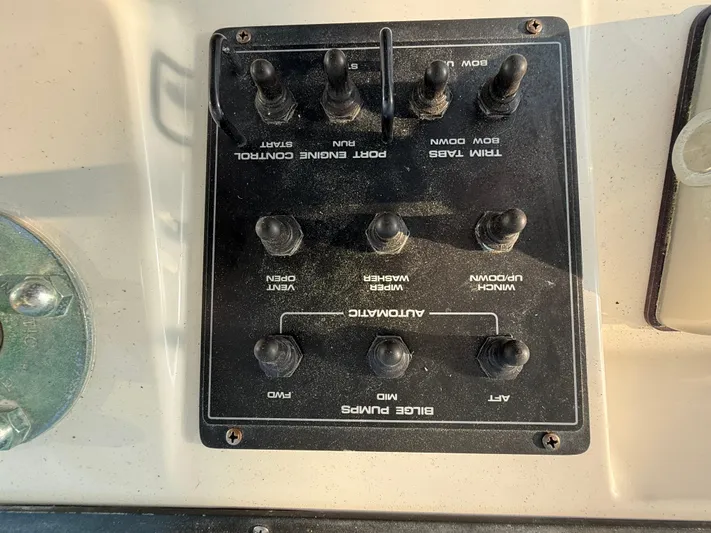 Club Car Yacht Photos Pics Control panel of a 1999 Cabo 31 Express boat with various switches.