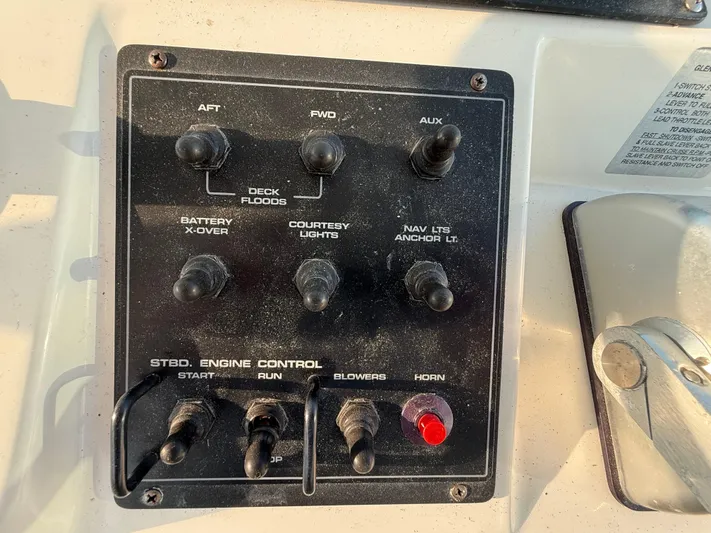 Club Car Yacht Photos Pics Control panel of a 1999 Cabo 31 Express boat with various switches and knobs.