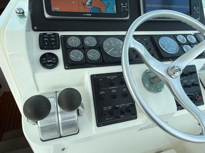 Club Car Yacht Photos Pics 1999 Cabo 31 Express boat dashboard with steering wheel and navigation controls.