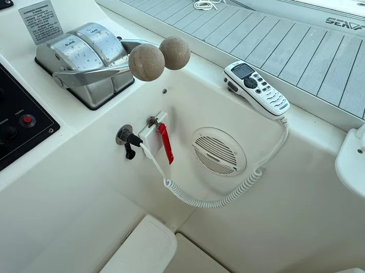 Club Car Yacht Photos Pics Control panel of a 1999 Cabo 31 Express boat with throttle and radio.