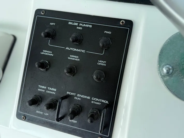 Club Car Yacht Photos Pics Control panel of a 1999 Cabo 31 Express boat with various switches.