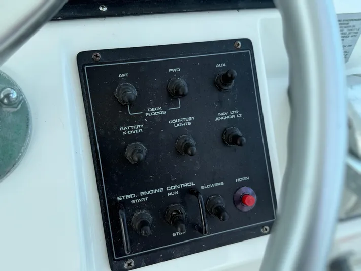 Club Car Yacht Photos Pics Control panel of a 1999 Cabo 31 Express boat with various switches.