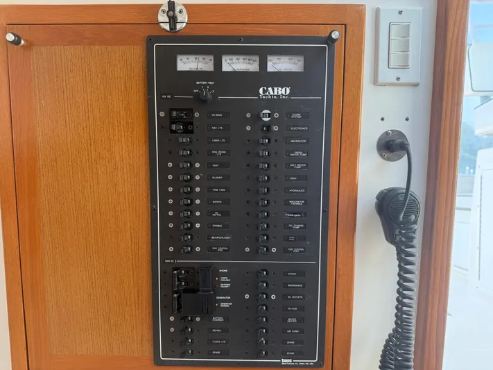 Club Car Yacht Photos Pics Electrical panel on a 1999 Cabo 31 Express yacht with various switches and gauges.